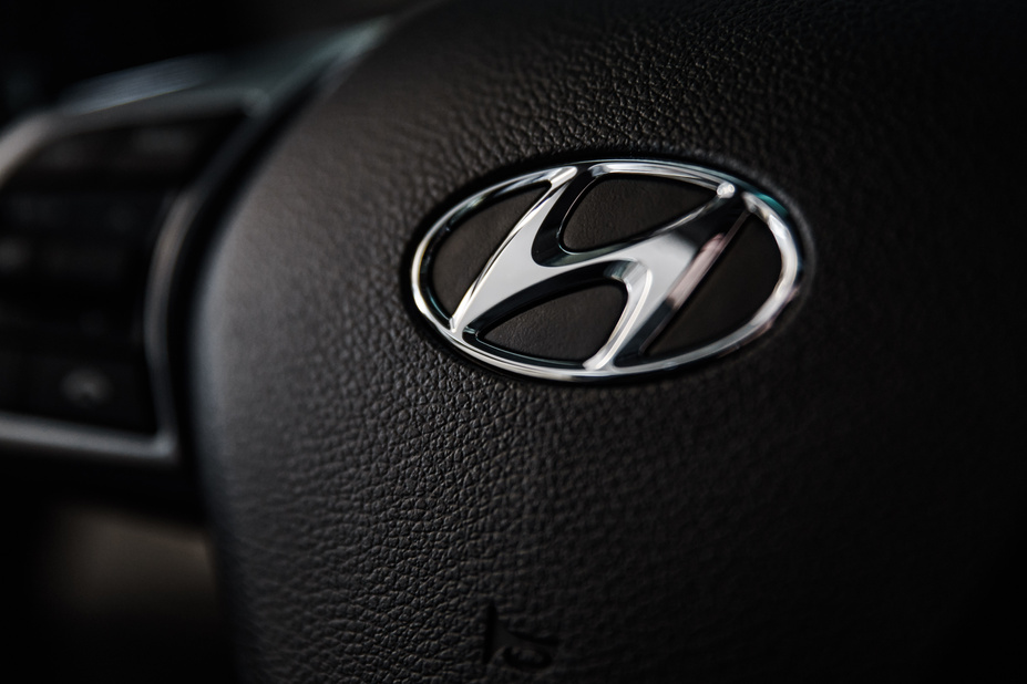 Shallow Focus Photography of Hyundai Emblem